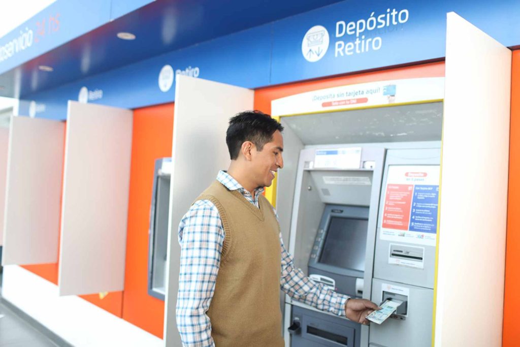 Man withdrawing money from an ATM in Cusco