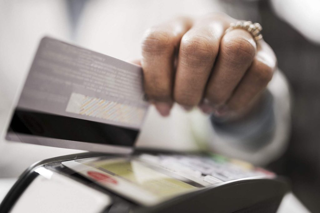 Person using a POS terminal with their credit card