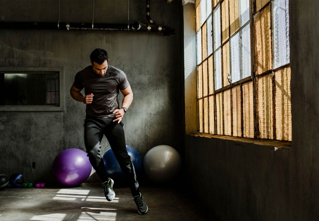 Person training for hiking with side jumps exercises