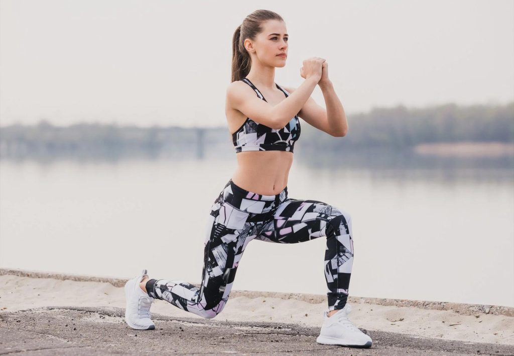 A woman training for hiking with walking lunges