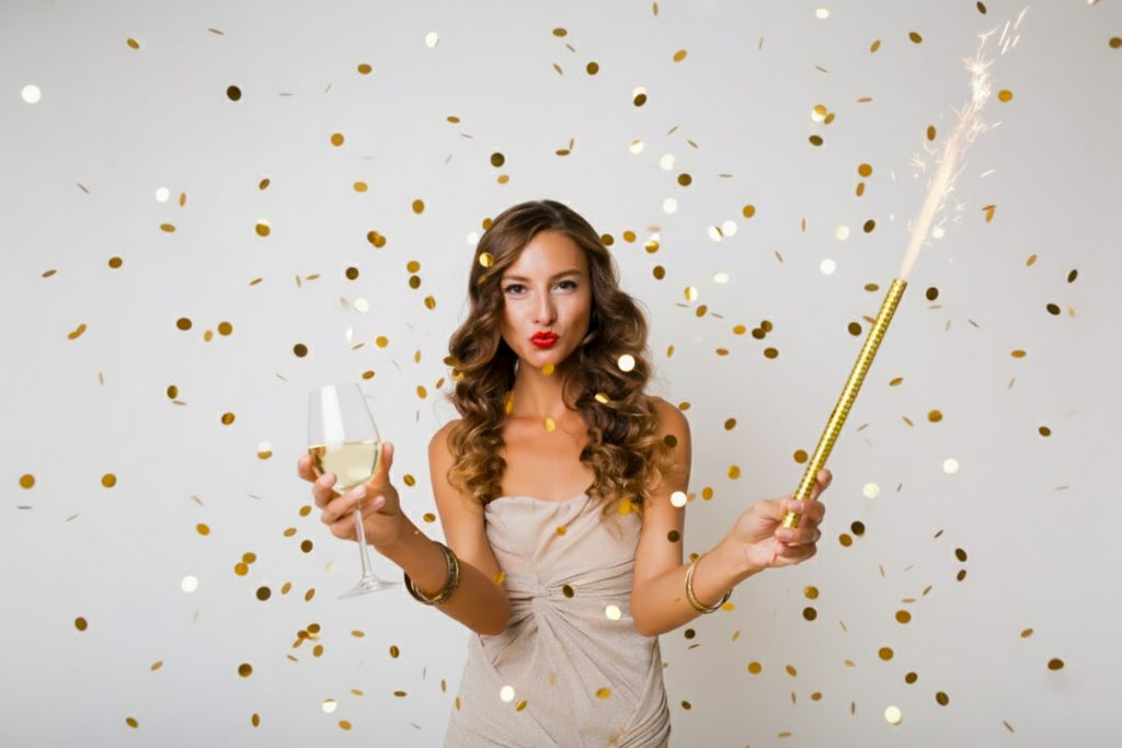 Woman celebrating the arrival of the new year with yellow confetti