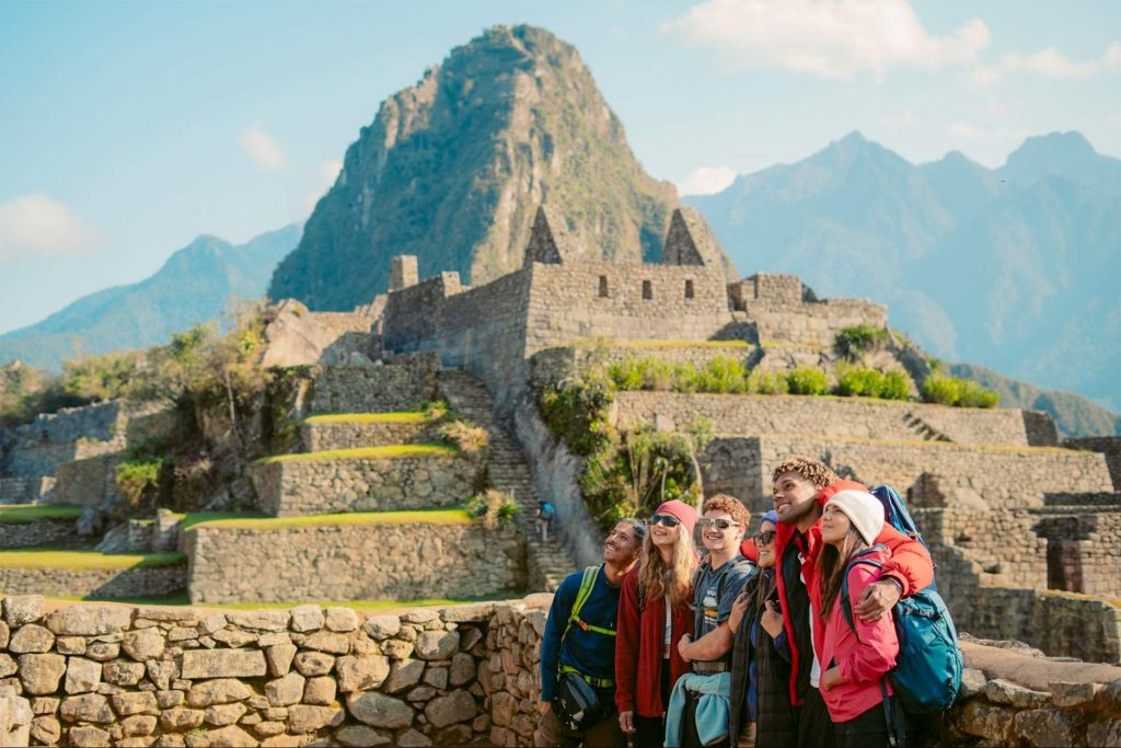 Tourists posing at the lower part of Machu Picchu