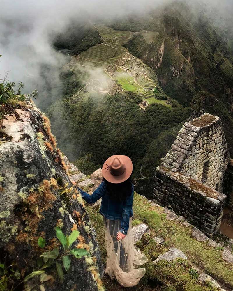 A tourist looking at Huayna Picchu Mountain in Machu Picchu
