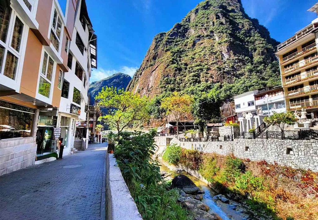Streets of Aguas Calientes, the town at the foot of Machu Picchu, with Putucusi Mountain in the background