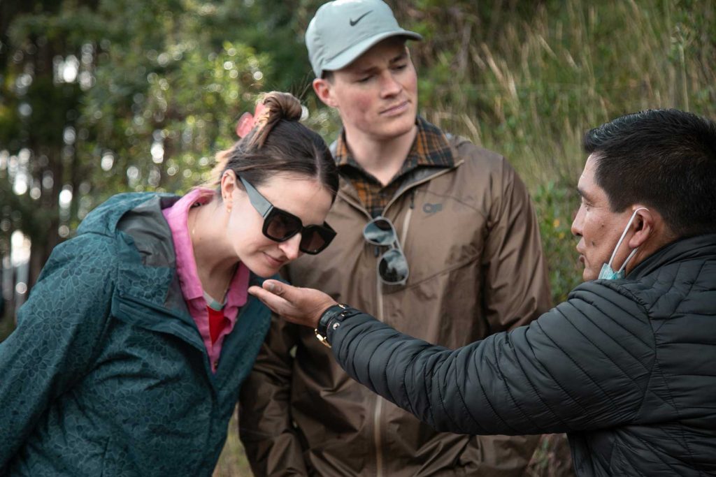 Tourist sniffing coca leaves on a city tour in Cusco.