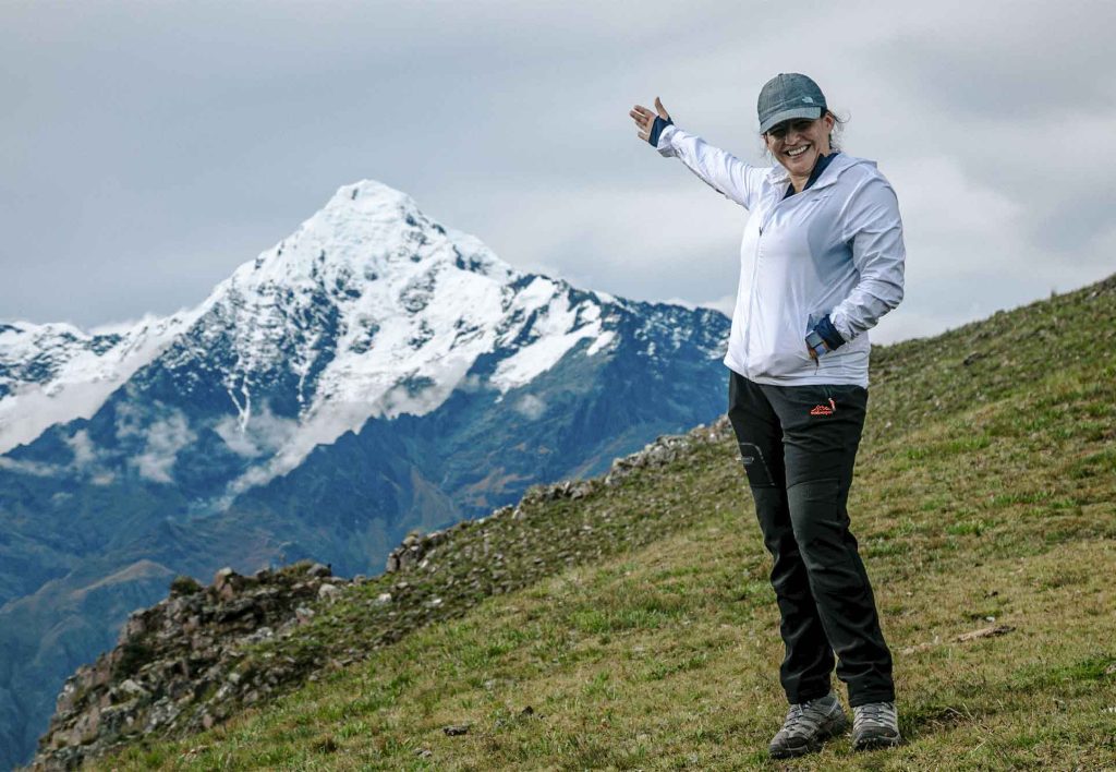 Tourist with the snow-capped Veronika mountain in the background on the Inca Quarry trail