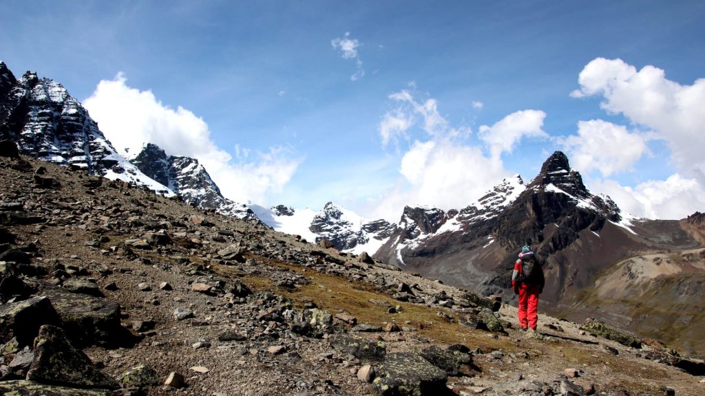 A stunning view of the snow-capped Condoriri peak reflecting in a high-altitude lagoon during the trek.