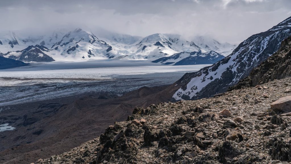 Hikers trekking through the challenging trails of the remote Huemul Circuit in Patagonia.