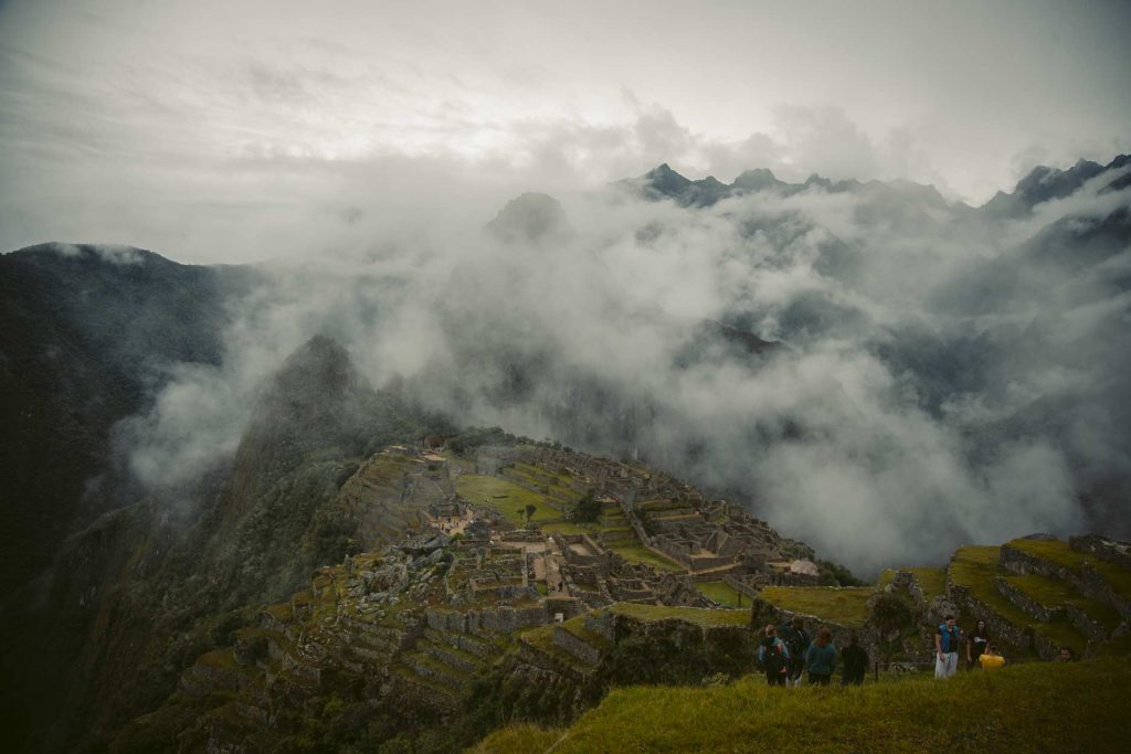 The citadel of Machu Picchu partially shrouded in mist.