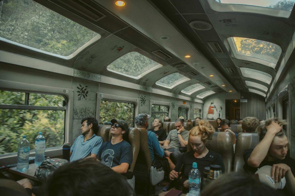 Tourists sitting on a train to Machu Picchu
