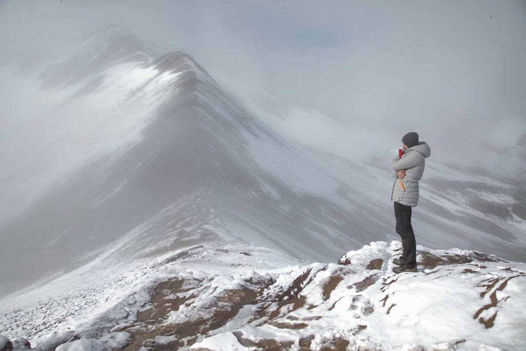 A tourist at Rainbow Mountain, in the freezing cold