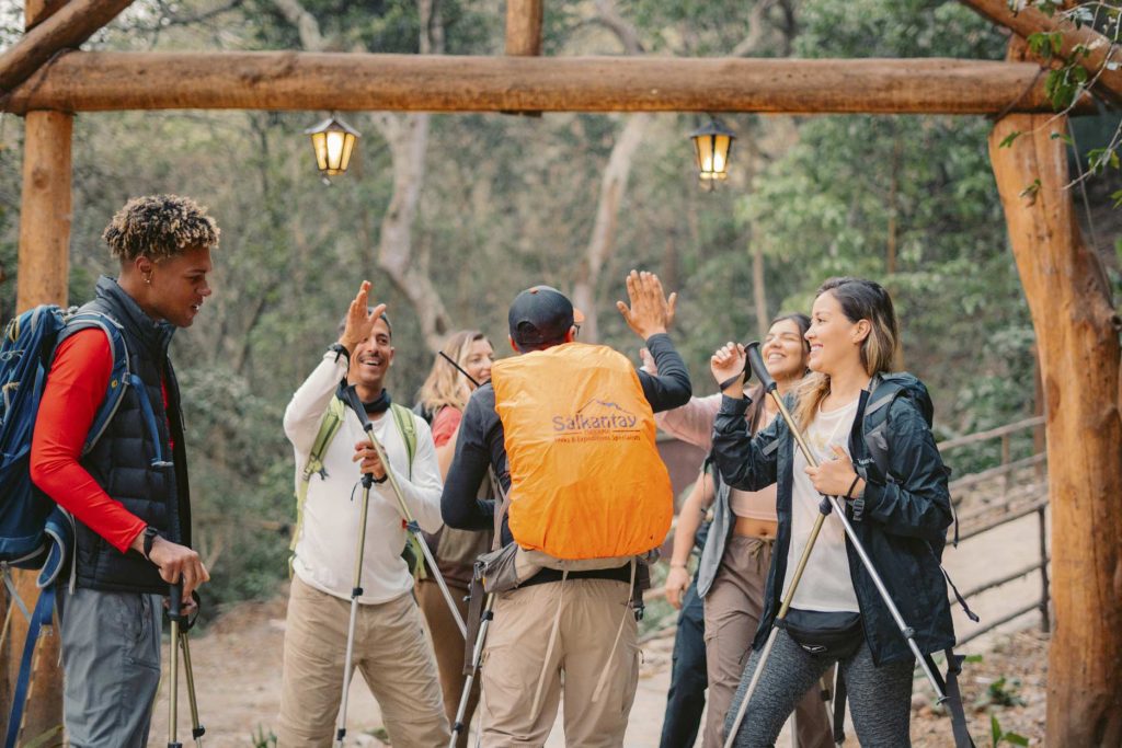 Group of tourists and their guide happy in the Andean jungle on the Salkantay route to Machu Picchu