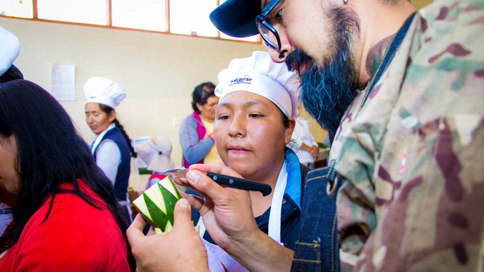 Cooks learning food handling and preparation techniques in a training session