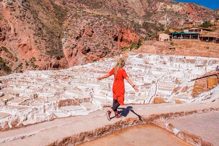 Tourist walking through the maras salt mines in the sacred valley of the Incas