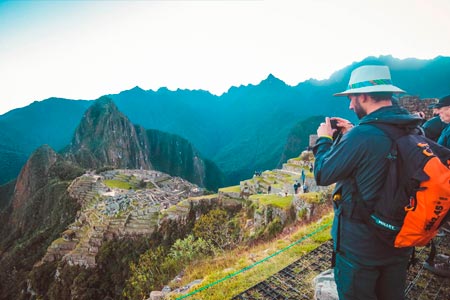 Tourist taking a photo to Machu Picchu