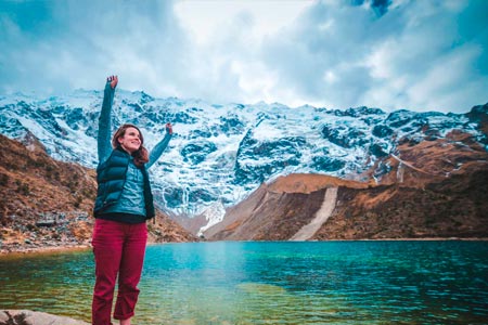 Tourist charging with energy in the Humantay lake
