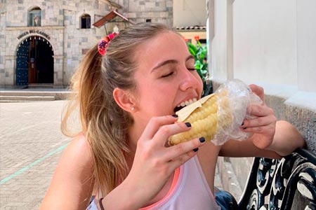 Tourist enjoying the delicious corn in the city of Cusco