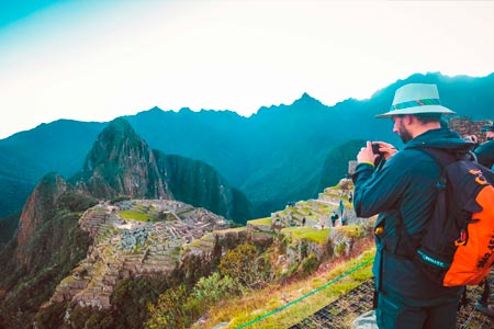 A tourist taking a photo on the Inca trail route to Machu Picchu