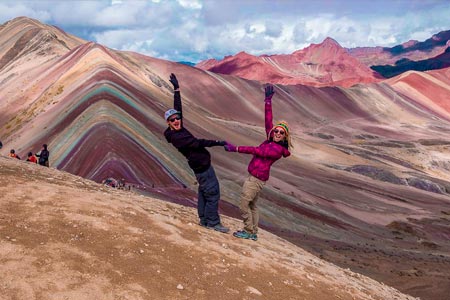 A couple of tourists in front of the rainbow mountain