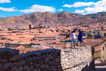Panoramic image of Cusco with a couple of tourists