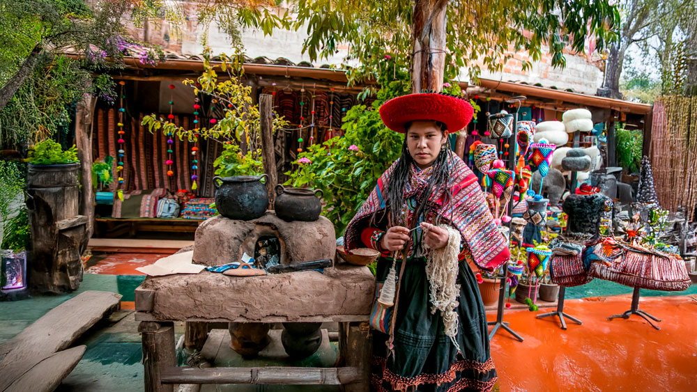 Andean woman making her traditional textiles