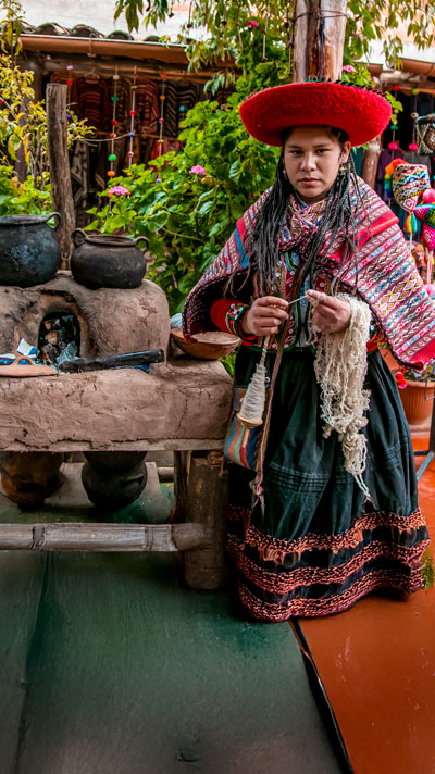 Andean woman making her traditional textiles