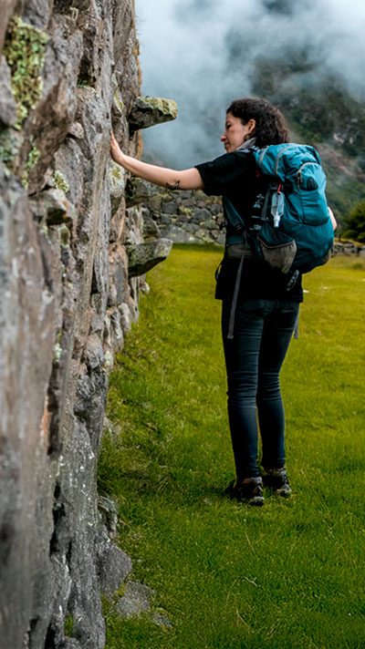 Tourist seeing a wonderful Inca construction on a tour in Cusco