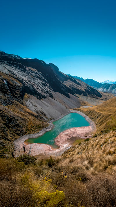 Traveler feeling the spirit of the Huayanay Glacier and the Ancascocha Lake.