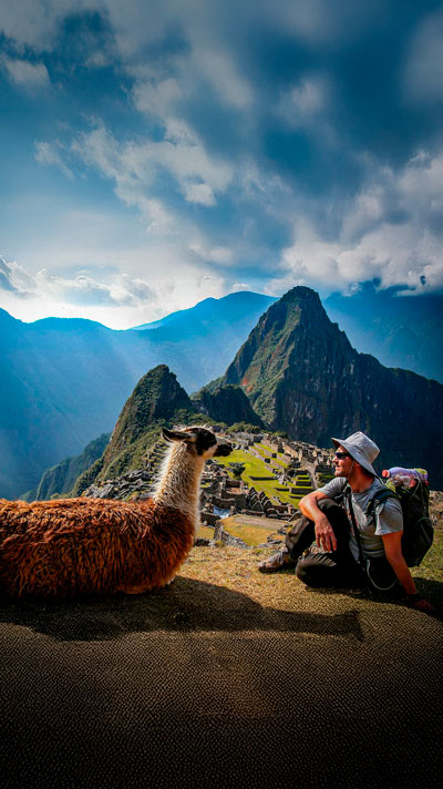 Lovely pic of the encounter of the natural habitants of Machu Picchu with a visitor, a llama and its guest in the Inca Sanctuary.