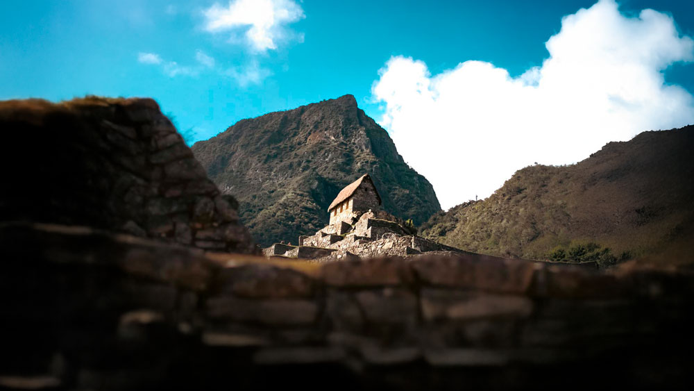 Woman hiking the incredible ancient Inca Trail to Machu Picchu near the cliff