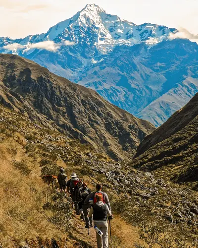 Tourists walking through the Andean mountains