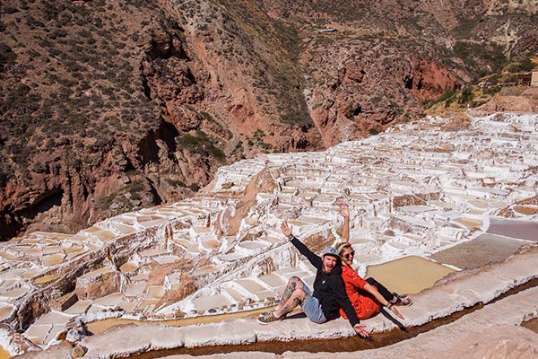 A happy tourist couple in the Salt Mines of Maras