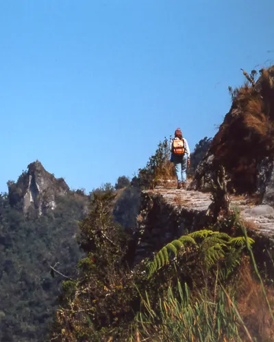 Panoramic view of the Inca trail with a tourist