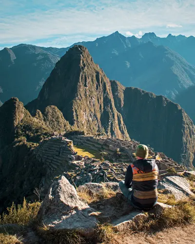 Tourist impressed by Machu Picchu after his walk along the famous Inca Trail