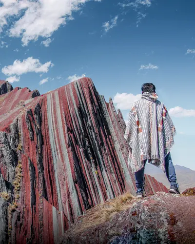 Tourist in front of Pallay Punchu mountain enjoying the beautiful view