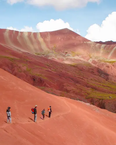 Tourists enjoying in the red valley next to the rainbow mountain
