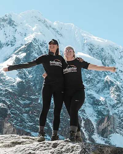 Two happy friends in the Salkantay pass on the trek to Machu Picchu