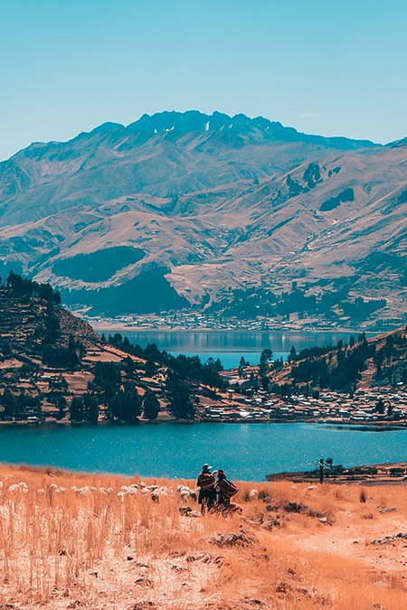Andean people in front of lagoons