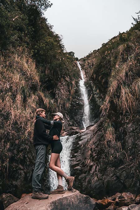Tourist couple at an impressive waterfall