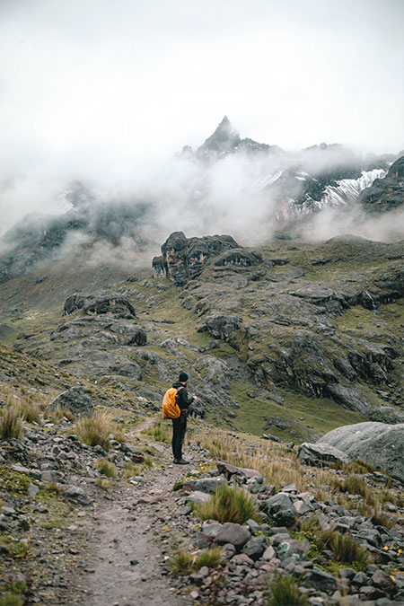 Tourist standing in front of the Andean Ausangate mountains