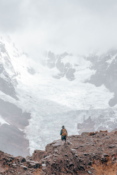Tourist in front of ausangate mountain in thick fog