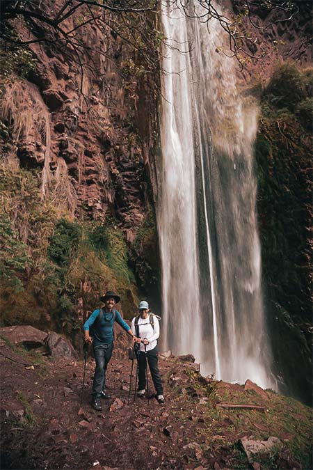 Tourist couple enjoying the Perolniyoc waterfall.