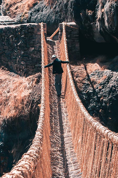 Tourist crossing Queswachaca bridge
