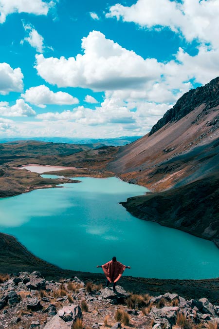 Tourist with an impressive panoramic view of the 7 lakes of Ausangate.