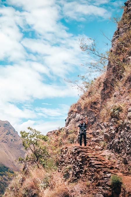 Tourist on the road on route Inca Jungle to Machu Picchu