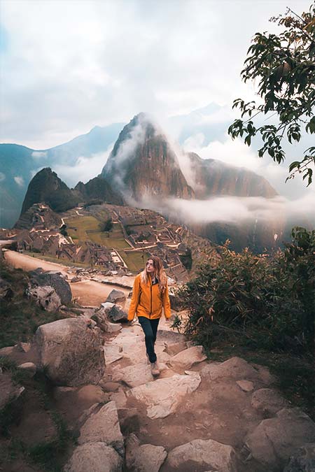 Tourist walking around the archeological site of Machu Picchu