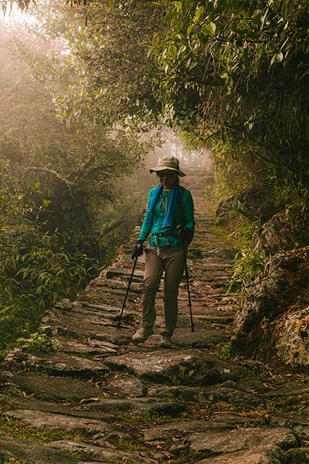 Tourist walking along the Inca Trail towards Machu Picchu