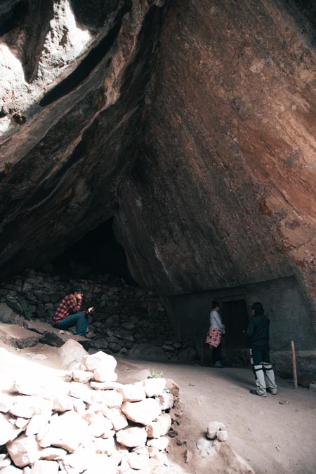 Two tourists with their guide at the archaeological site of Racaypata