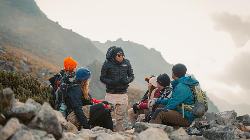 Salkantay Trekking guide talking with a group on a mountain pass